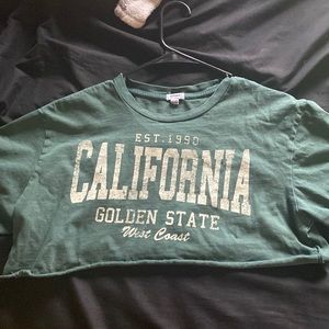 Forest green shirt with tan wording, is an XS, from Garage.